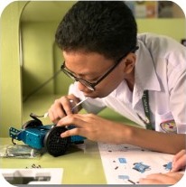 Student assembling a robot